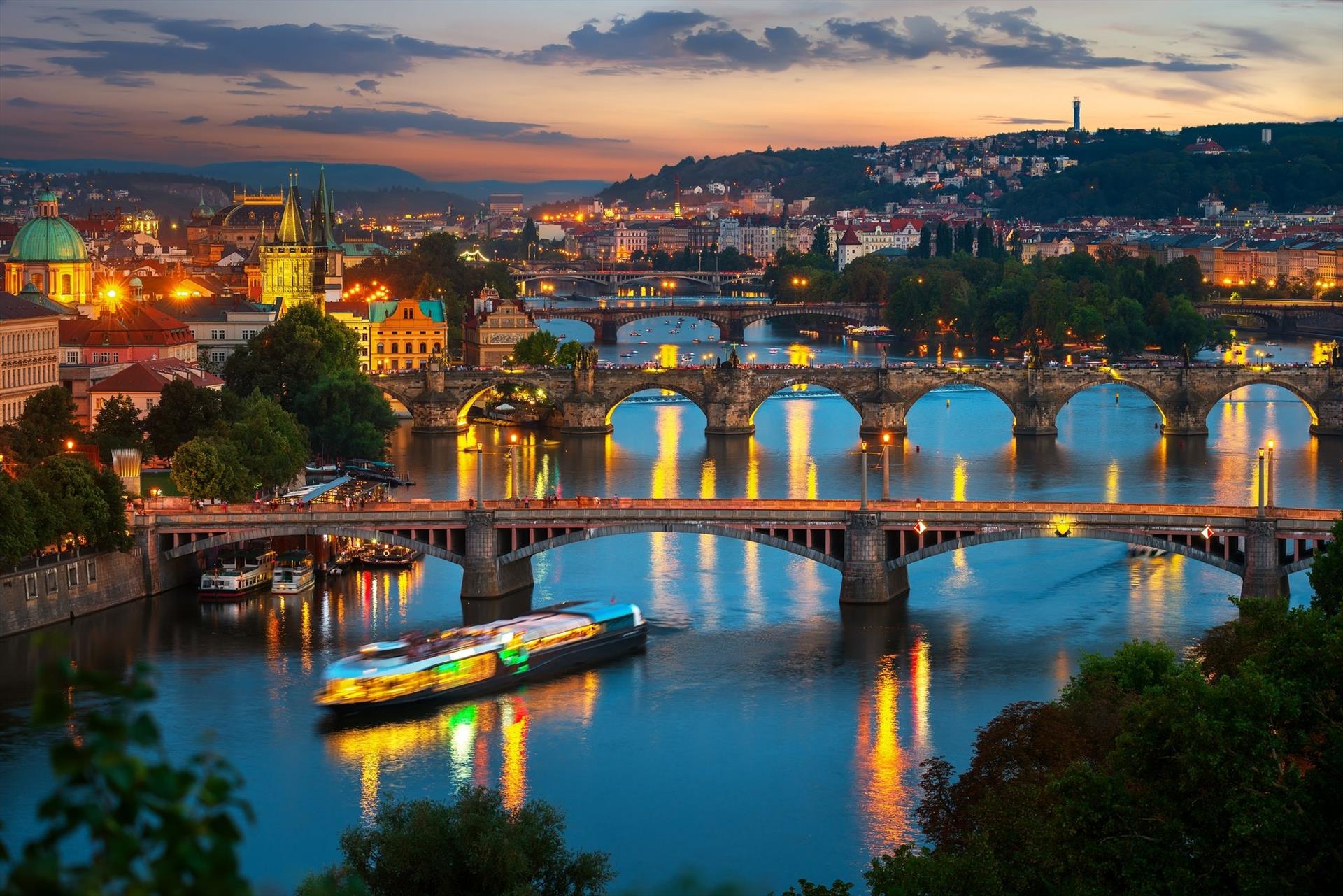 Prague dinner cruise at night with Charles Bridge and Prague Castle views